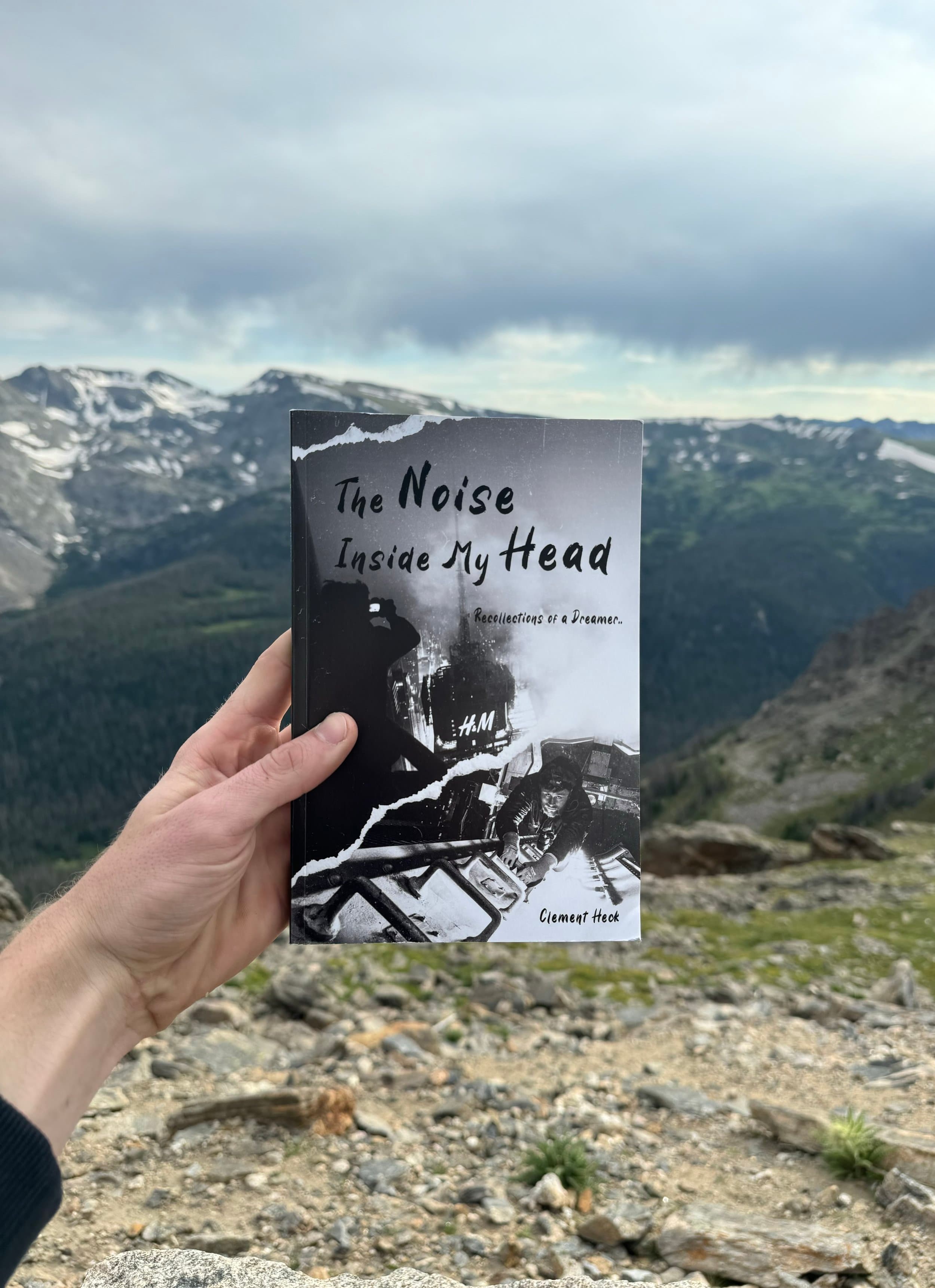 The Noise Inside My Head held in front of mountain landscape